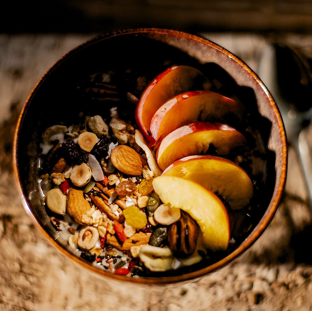 Bowl of 7th Heaven Granola with apple slices